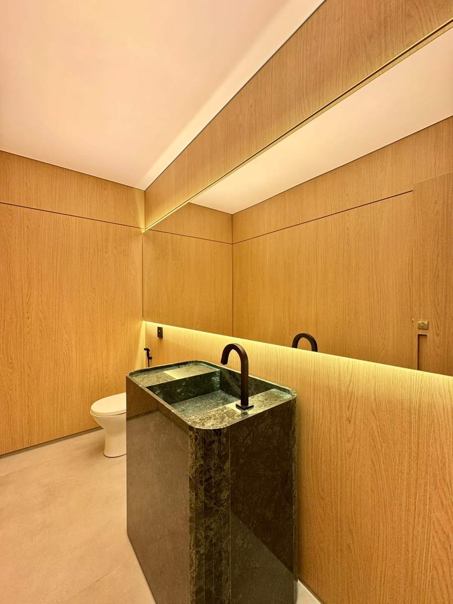 Lavabo revestido em madeira com cuba esculpida em pedra