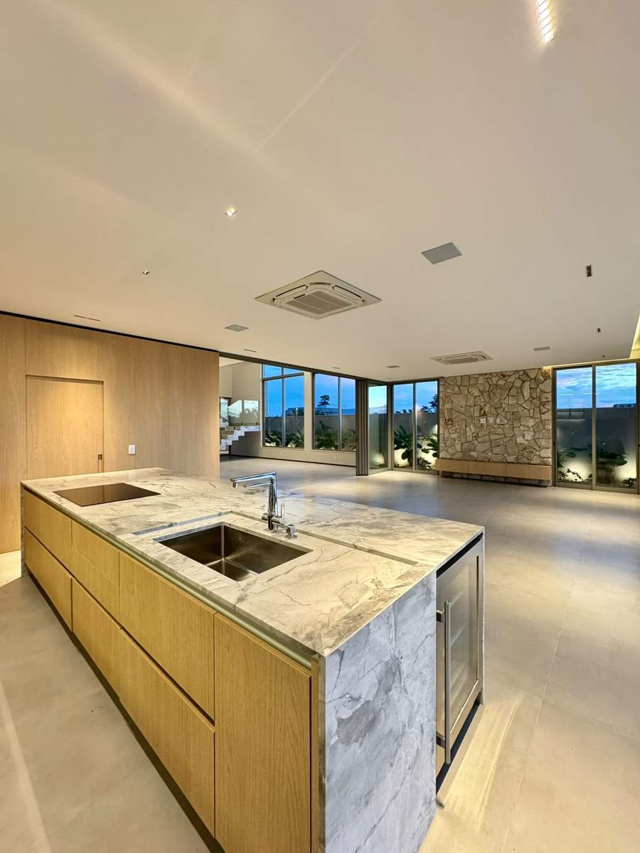 Cozinha gourmet com ilha em mármore e adega climatizada