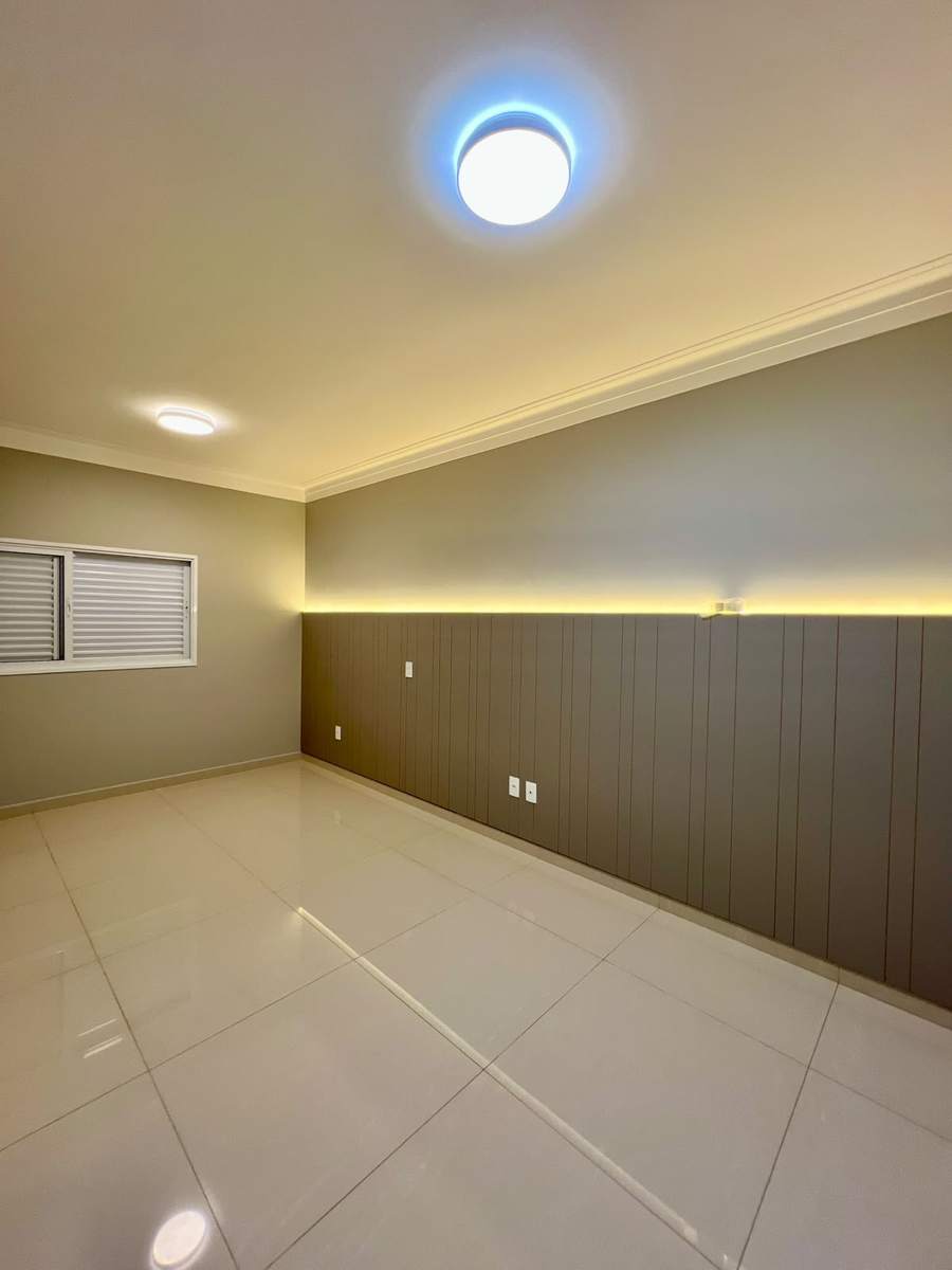 Dormitório com painel ripado e iluminação indireta