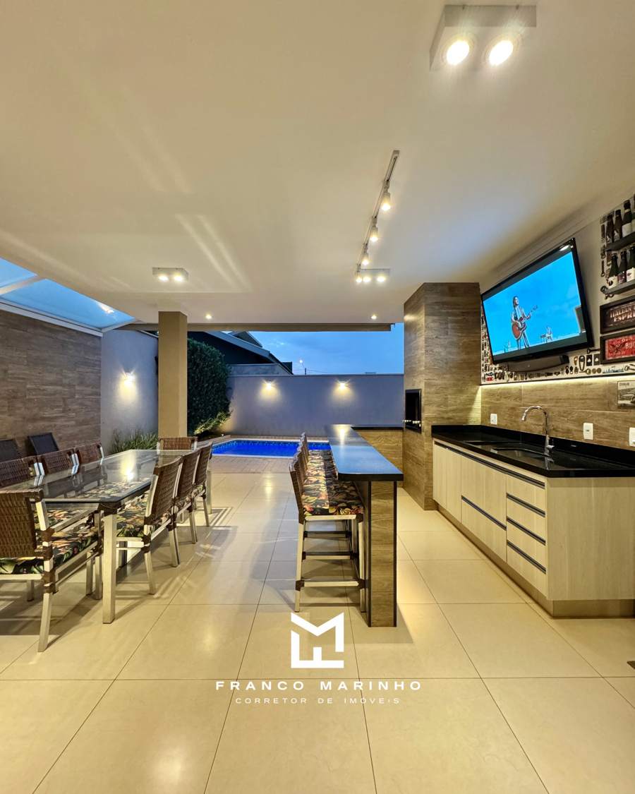 Varanda gourmet com churrasqueira, bar e vista para a piscina